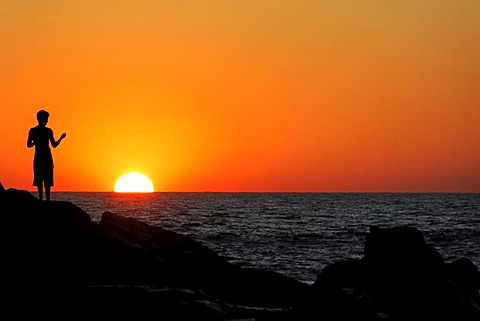 Silhouette of a person at sunset, the beach of Las Penitas near Poneloya, Leon, Pacific, Nicaragua, Central America