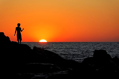 Silhouette of a person at sunset, the beach of Las Penitas near Poneloya, Leon, Pacific, Nicaragua, Central America