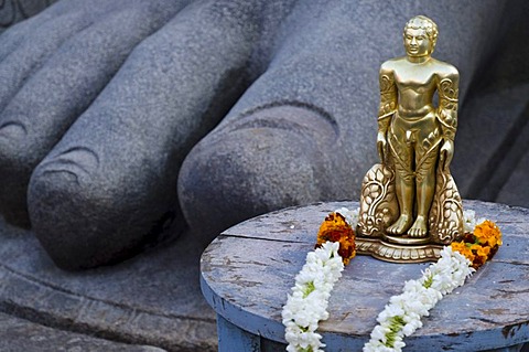 The small statue of Bahubali at the feet of the gigantic staue of Gomateshwara in Sravanabelagola, used for special rituals, Karnataka, India, Asia