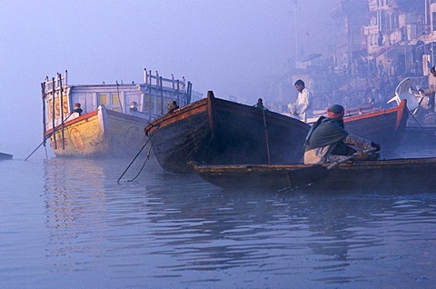 Boats on river Ganges, waiting to take pilgrims for a ride on the holy river, Varanasi, Uttar Pradesh, India, Asia