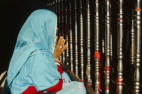 Woman praying at a temple in the holy place Baba Ram Dev, Jaisalmer, Rajasthan, India, Asia