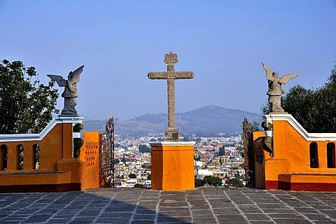 Cross and angels with a view towards the city from the church of Iglesia Nuestra Senora de los Remedios, built on the pre-Hispanic Pyramid of Cholula, San Pedro Cholula, Puebla, Mexico, Latin America, North America