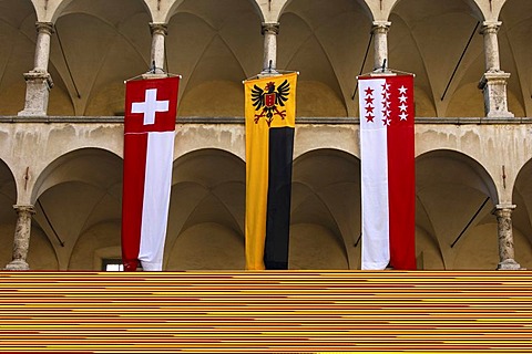 Flags of Switzerland, the municipality of Brig-Glis and the canton of Valais in the courtyard of the Stockalper Palace, Brig, Valais, Switzerland, Europe