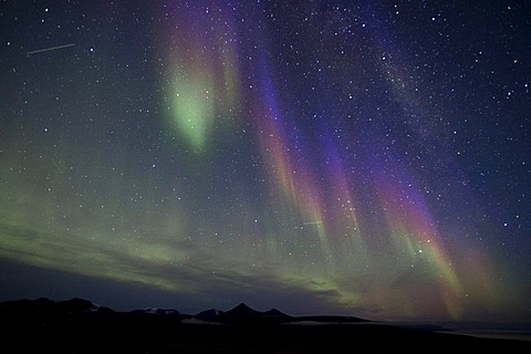 Green, blue and purple northern lights, aurora borealis, with light trails of two satellites, Spitsbergen, Svalbard, Norway, Scandinavia, Europe