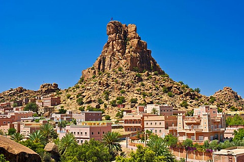 Small village of Aguard Oudad with colourfully painted houses in front of the imposing rocks of Chapeau Napoleon, Napoleon's Hat, Tafraoute, Anti-Atlas Mountains, southern Morocco, Morocco, Africa