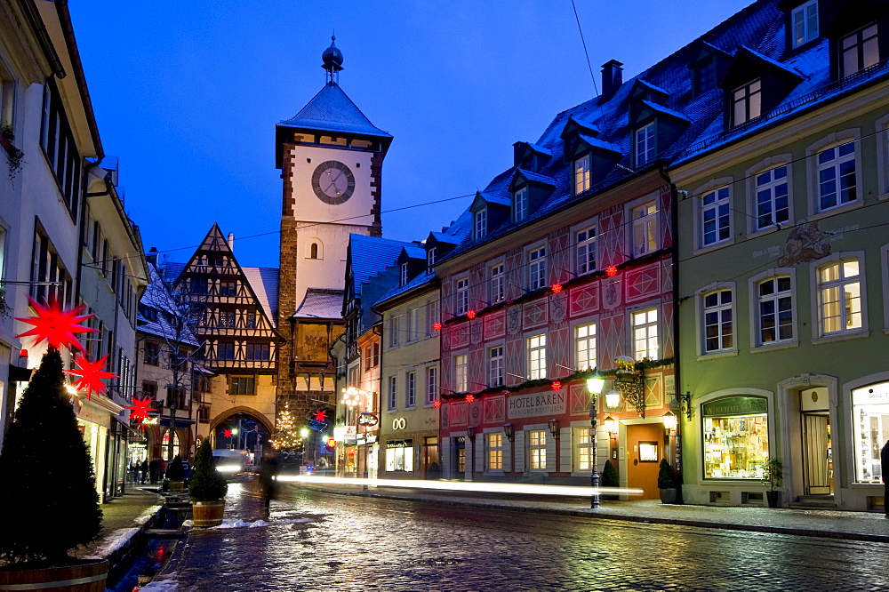 Schwabentor gate tower and Christmassy and snowy old town of Freiburg im Breisgau, Black Forest, Baden-Wuerttemberg, Germany, Europe