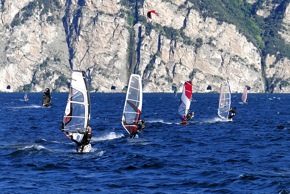 Wind surfers surfing in strong winds on Lake Garda in Malcesine, Veneto, Italy, Europe