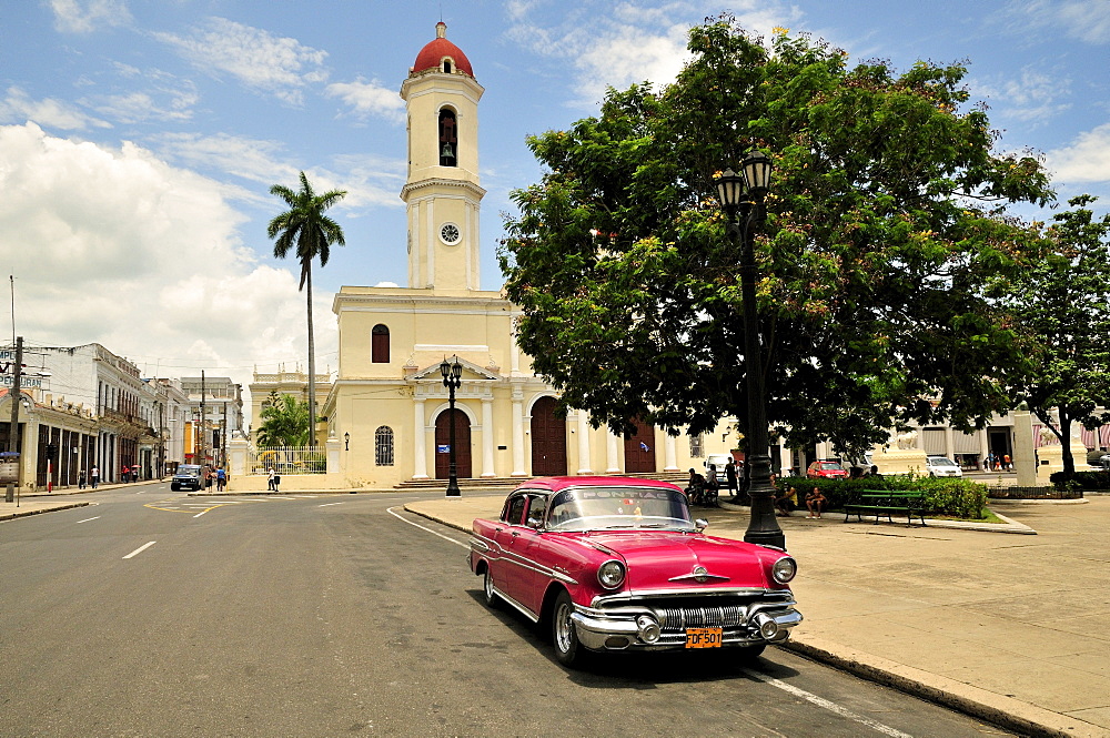 Pontiac, classic car parked in front of the Cathedral de la Purisma Concepcion next to Parque Marti park, Cienfuegos, Cuba, Caribbean