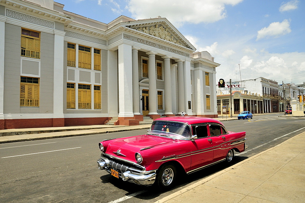 Pontiac, classic car parked in front of the Colegio San Lorenzo school next to Parque Marti park, Cienfuegos, Cuba, Caribbean