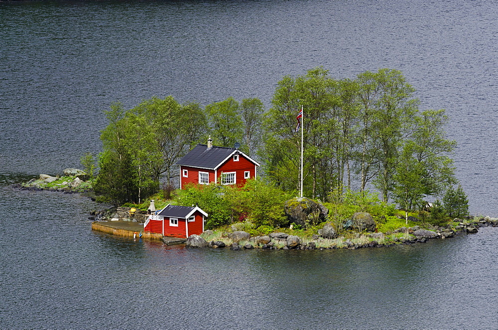 Remote island with a red cottage in Lovrafjord, Norway, Scandinavia, Europe