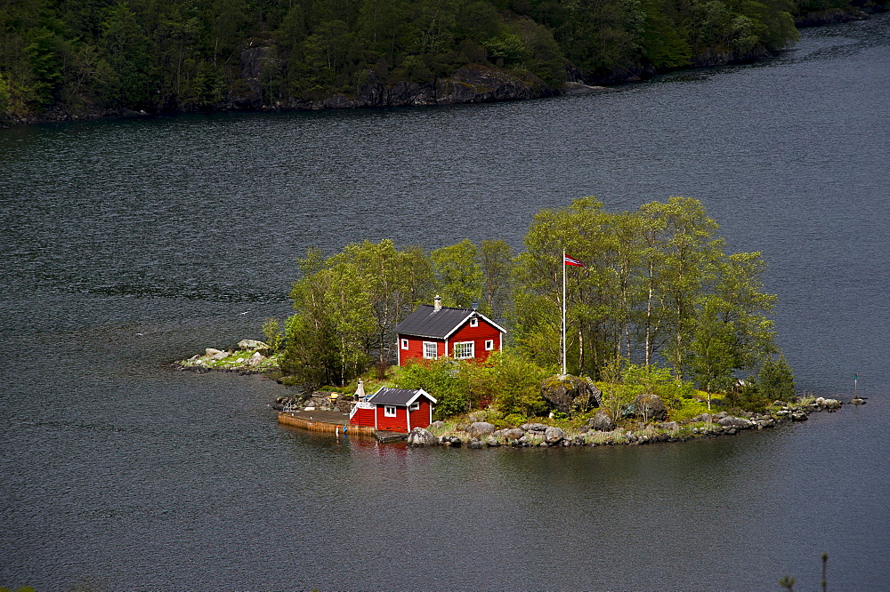 Remote island with a red cottage in Lovrafjord, Norway, Scandinavia, Europe