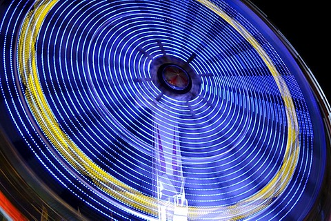 Bright blue illuminated spinning carousel, Oktoberfest 2010, Munich, Upper Bavaria, Bavaria, Germany, Europe