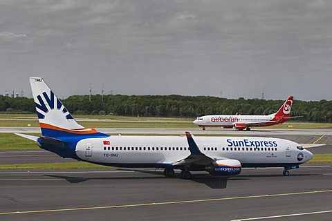 Boeing 737 800 of the Turkish SunExpress on the runway, behind an airberlin airplane, Duesseldorf International Airport, Duesseldorf, North Rhine-Westphalia, Germany, Europe