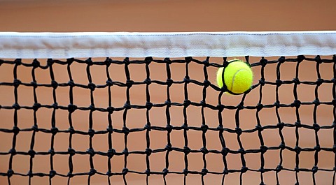 Tennis ball caught in the net