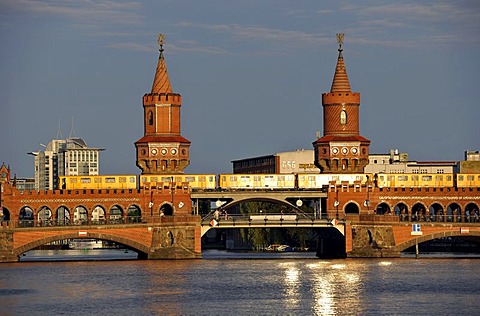 U-Bahn U1 train on Oberbaumbruecke bridge crossing the Spree River in the evening light, Friedrichshain-Kreuzberg, Berlin, Germany, Europe