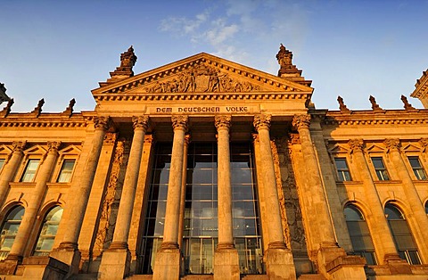 Evening light on the Reichstag German Parliament, words "Dem Deutschen Volke" or "To the German People" and relief in the tympanum over the main portal, Government District, Tiergarten district, Berlin, Germany, Europe