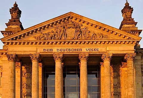 Evening light on the Reichstag German Parliament, words "Dem Deutschen Volke" or "To the German People" and relief in the tympanum over the main portal, Government District, Tiergarten district, Berlin, Germany, Europe