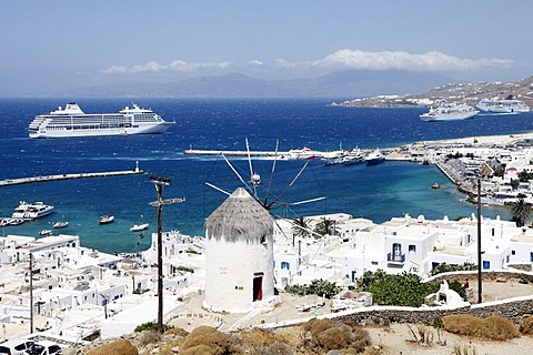 View over the bay and the port with the Boni Milos windmill, Mykonos town, Mykonos, Greece, Europe