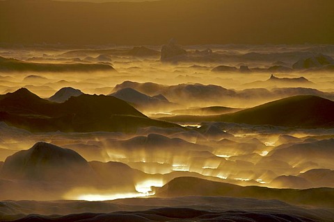 Reflection of the setting sun in the fog over the Joekulsarlon glacial lake, south coast, Iceland, Europe