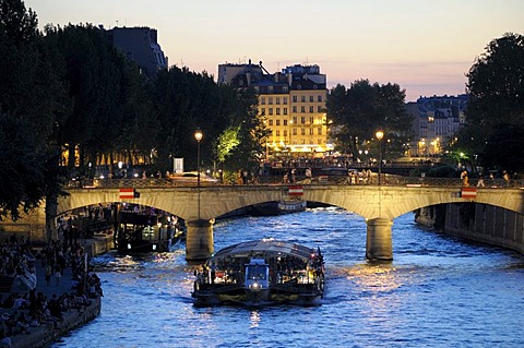 Sightseeing boat at dusk, Seine River, Paris, France, Europe