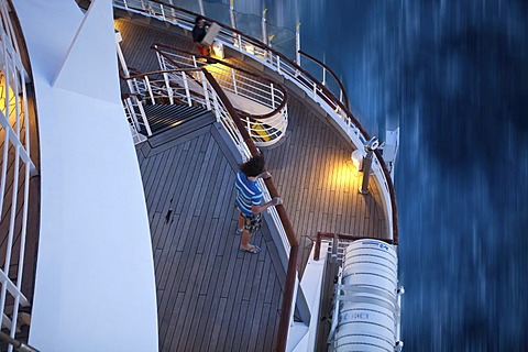 Young man standing at the railing at dusk, Aida Club Cruiser, during travel, Corsica, France, Europe - Attention: Restricted right of use! Please ALWAYS contact the press office before publishing this picture: AIDA Cruises, Am Strande 3d, 18055 Rostock, G