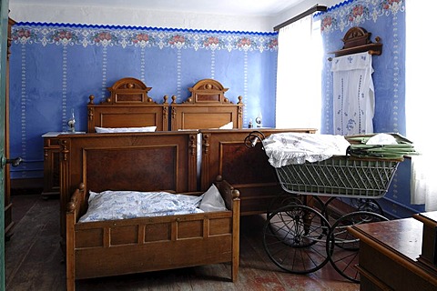 Bedroom, in front cradle and baby carriage, 1935, teacher's apartment in a school building from Pfaffenhofen, built in 1801, Franconian open-air museum, Eisweiherweg 1, Bad Windsheim, Middle Franconia, Bavaria, Germany, Europe