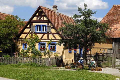 Haeckerhaus building, 1706, left, left, on the right a barn, 1590, both from Ergersheim, in front two basket weavers, Franconian open-air museum, Eisweiherweg 1, Bad Windsheim, Middle Franconia, Bavaria, Germany, Europe