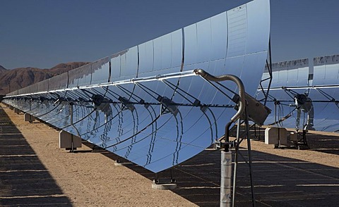 A solar electric generating system operated by Sunray Energy; the parabolic mirrors focus the sun's rays to heat an oil-filled tube, the heat produces steam to run an electricity-generating turbine, Daggett, Mojave Desert, southern California, USA