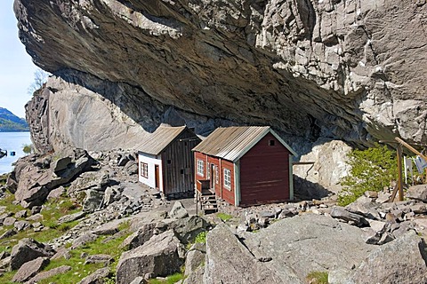 Houses under Helleren mountain ledge, Sokndal, Norway, Europe