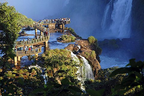 Footbridge with tourists at the Iguazu Falls at the border between Argentine and Brazil