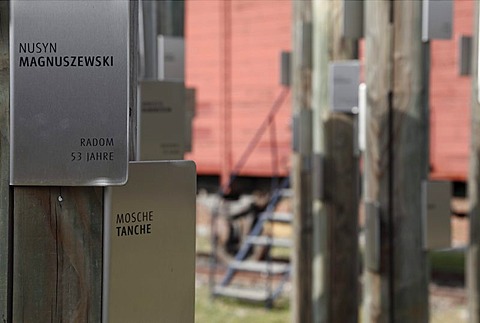 Posts with name tags of Jewish prisoners in front of a carriage used to transport the prisoners, memorial at Hessental Concentration Camp, Schwaebisch Hall, Baden-Wuerttemberg, Germany, Europe