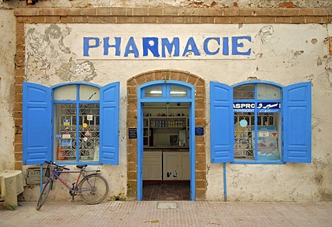 The facade of a pharmacy with a blue door frame and blue window shutters in Essaouira, Morocco, Africa