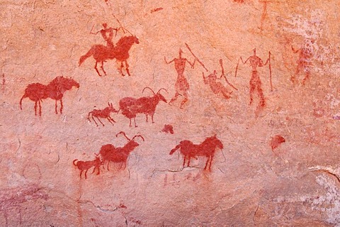 Painted rider and goats, neolithic rockart of the Acacus Mountains or Tadrart Acacus range, Tassili n'Ajjer National Park, Unesco World Heritage Site, Algeria, Sahara, North Africa