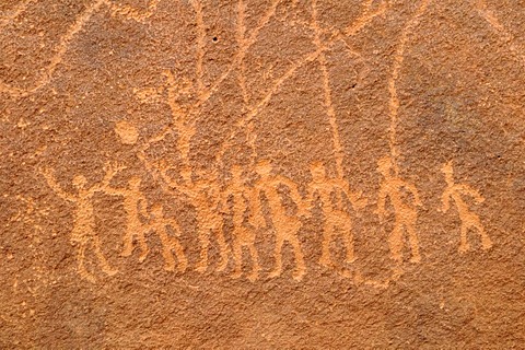 Engraving of a group of people, neolithic rockart of the Acacus Mountains or Tadrart Acacus range, Tassili n'Ajjer National Park, Unesco World Heritage Site, Algeria, Sahara, North Africa