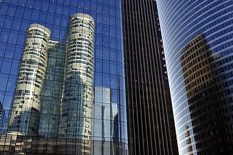 Skyscrapers, Tour Coeur Defense reflected in the glass facade of the Opus 12 building, right Tour EDF tower, La Defense, Paris, France, Europe