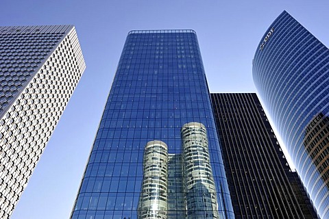 Skyscrapers, Tour Coeur Defense reflected in the glass facade of the Opus 12 building, between the Tour Initiale, left, and Tour EDF towers, right, La Defense, Paris, France, Europe