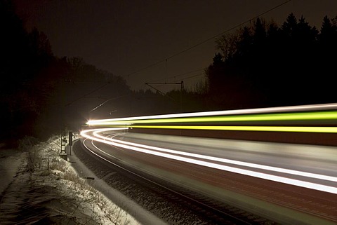 Train as a light trace in winter at night, Beimerstetten, Baden-Wuerttemberg, Germany, Europe