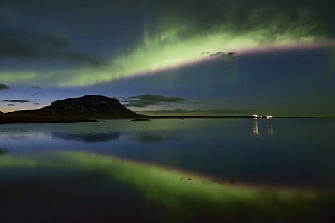 Strong Northern Lights (Aurora borealis) reflected at dusk in the fjord over the Mt. Brimlarhoefï£¿i in Grundarfjoerï£¿ur, SnÃŠfellsnes, Iceland, Europe