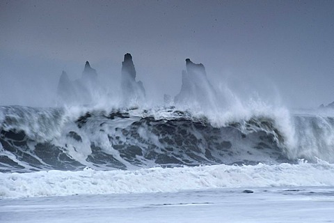 The Reynisdrangar pinnacles between by strong waves on the wintry Reynisfjara beach at Vik I Myrdal, Iceland, Europe