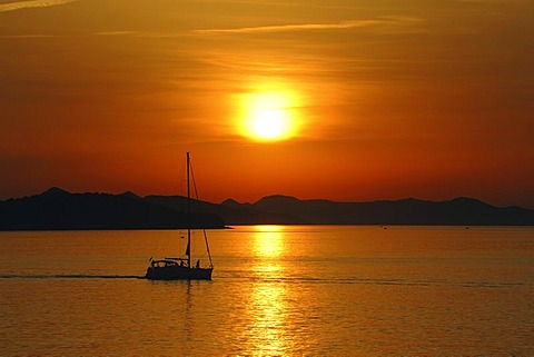 Small boat at sunset, off the Adriatic Sea coast at Dubrovnik, Croatia, Europe