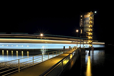 Light trace of the moving Euregia ferry and the illuminated Molenturm tower in the ferry port of Friedrichshafen, Bodenseekreis district, Baden-Wuerttemberg, Germany, Europe