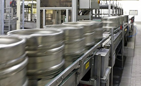 Beer kegs on a conveyor belt, waiting to be filled, with motion blur, Binding brewery, Frankfurt, Hesse, Germany, Europe