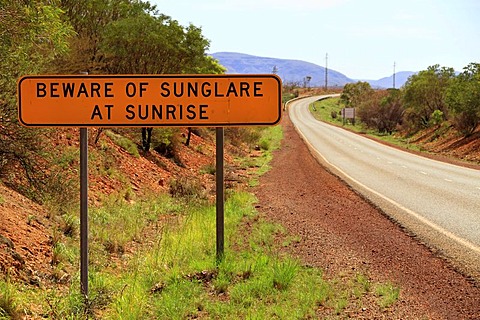 Warning sign, Beware of sunglare at sunrise, next to a road, Pilbara, Western Australia, Australia