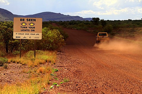 Warning sign, Turn your lights on, next to a road, Pilbara, Western Australia, Australia