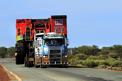 Heavy mine machinery being transported by road train trucks, Pilbara, Western Australia, Australia