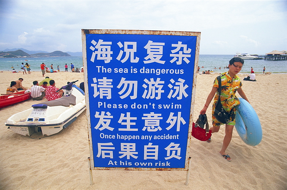 Public Awareness sign and swimmers, Dadonghai Beach, Sanya, Hainan Island, China, Asia