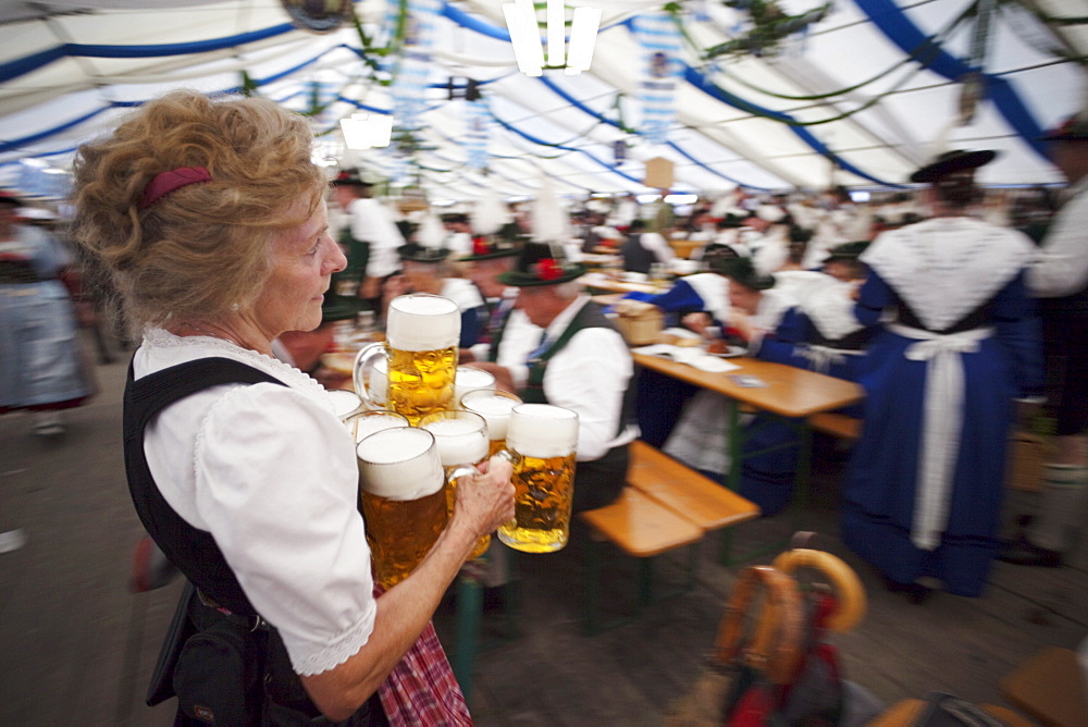 Waitress holding beer steins, Oktoberfest, Munich, Bavaria, Germany, Europe