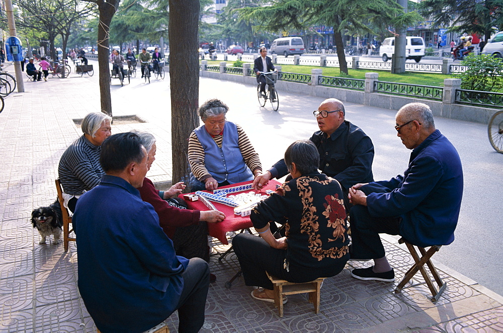 Elderly men and women playing Mahjong in the street, Beijing, China, Asia