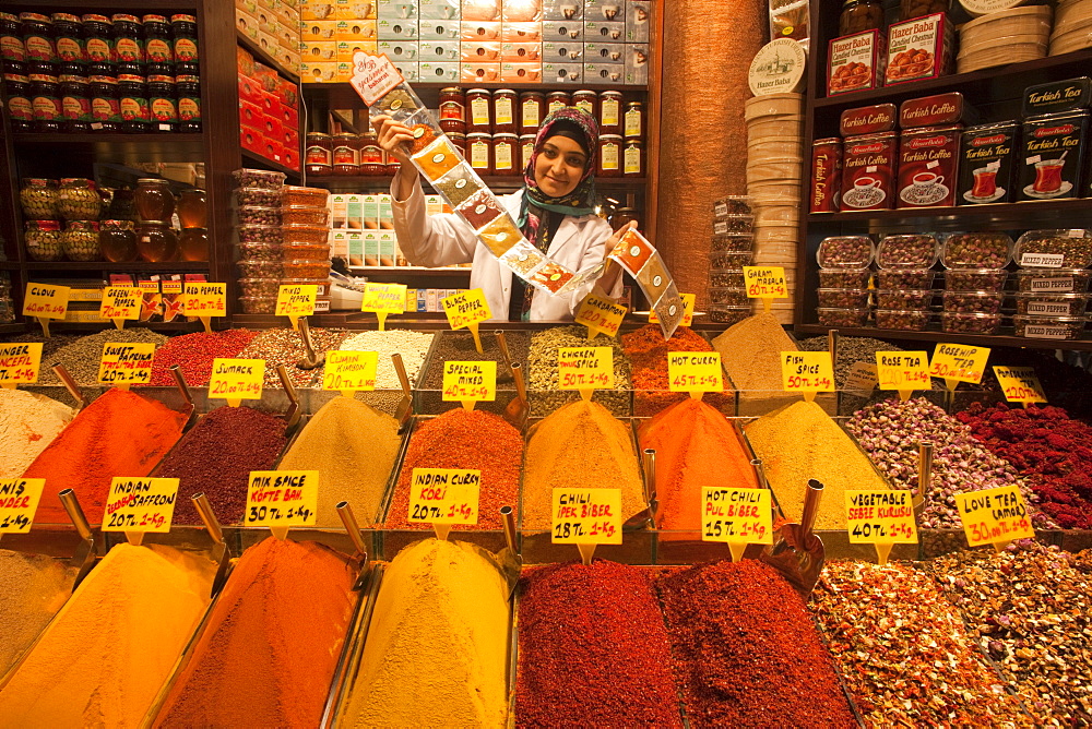 Woman selling spices in a typical shop in the Spice Bazaar, Sultanahmet, Istanbul, Turkey, Europe