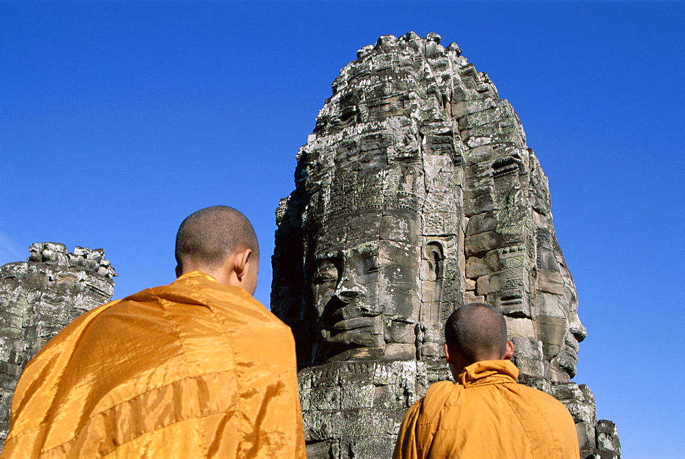 Two monks at the temple towers of the Bayon, Angkor Thom, UNESCO World Heritage Site, Siem Reap, Cambodia, Indochina, Southeast Asia, Asia